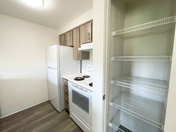 A small kitchen with a refrigerator and a stove and